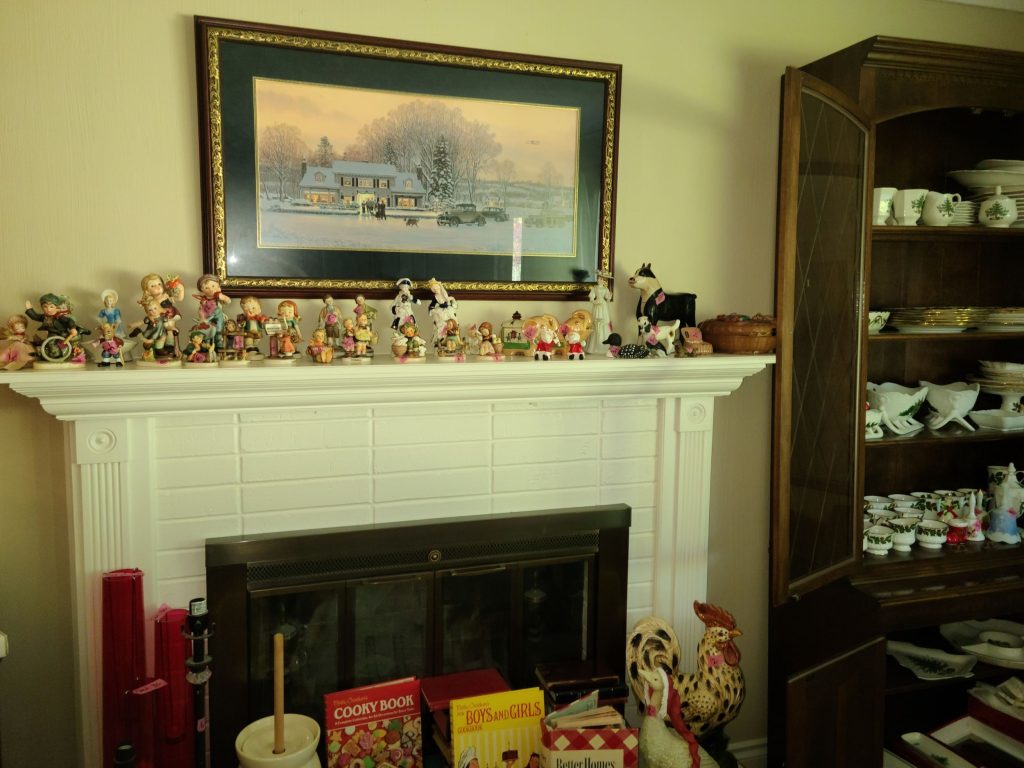 Living room with a fireplace and framed painting set up for an estate sale in Tri-Cities, WA