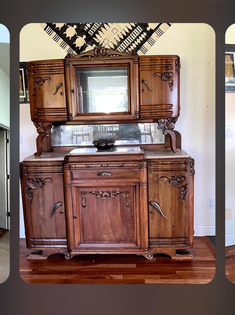 Carved antique wooden sideboard with mirror at a Tri-Cities estate sale