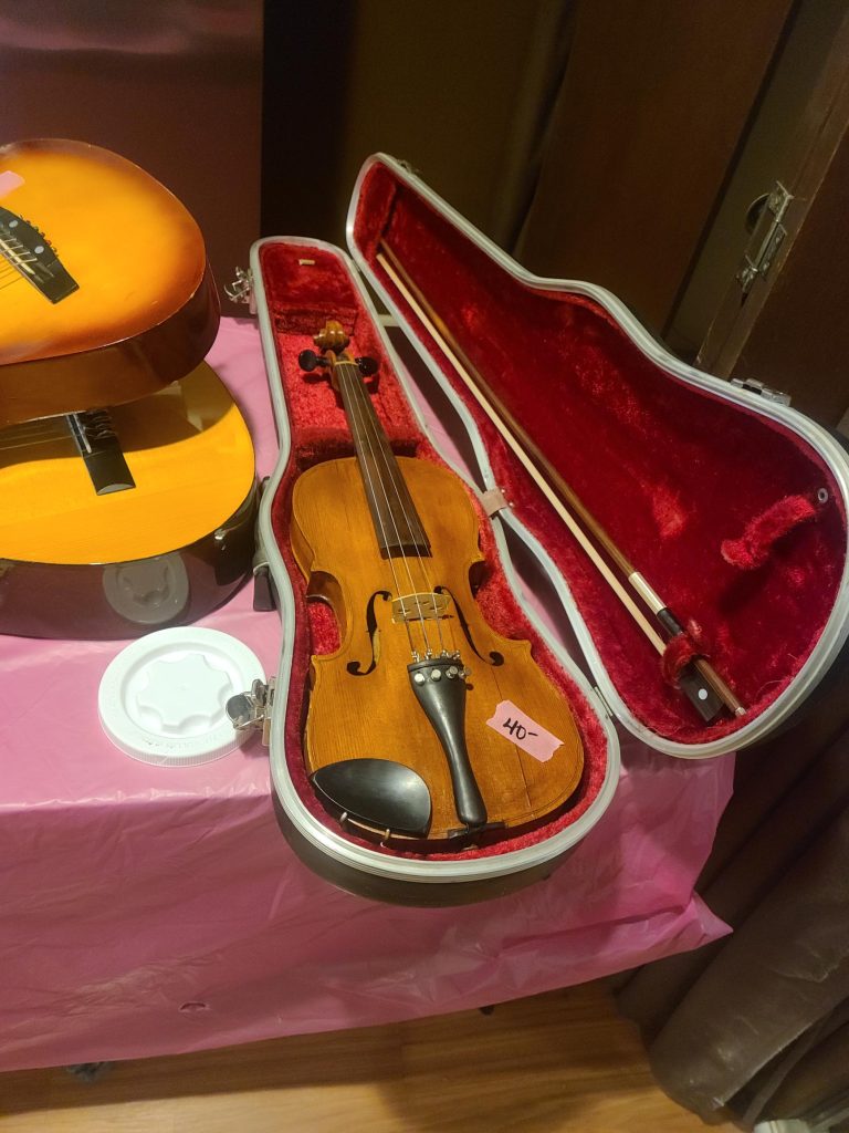 Violin in its case for sale at a Tri-Cities estate sale